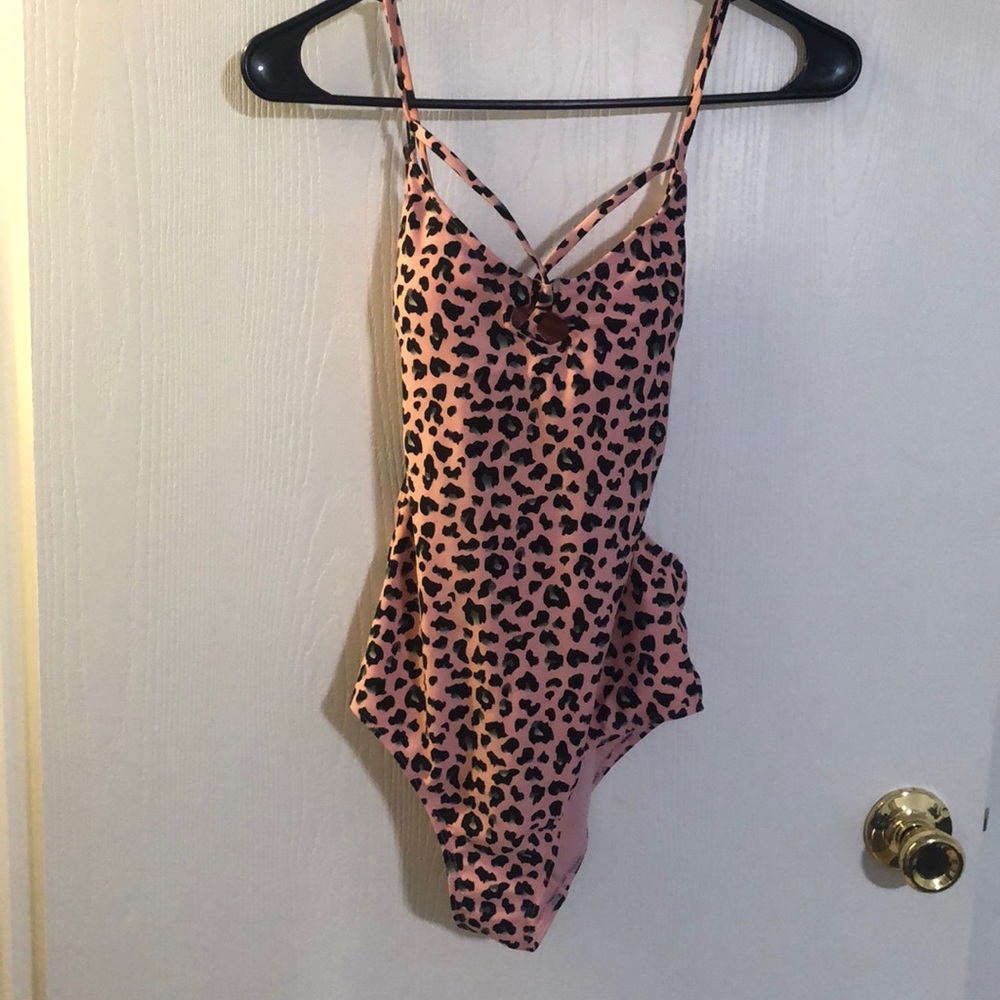 A cheetah printed one piece bathing suit pink black grey and white